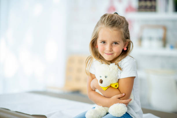 istock Smiling Girl With Teddy Bear 1072614220