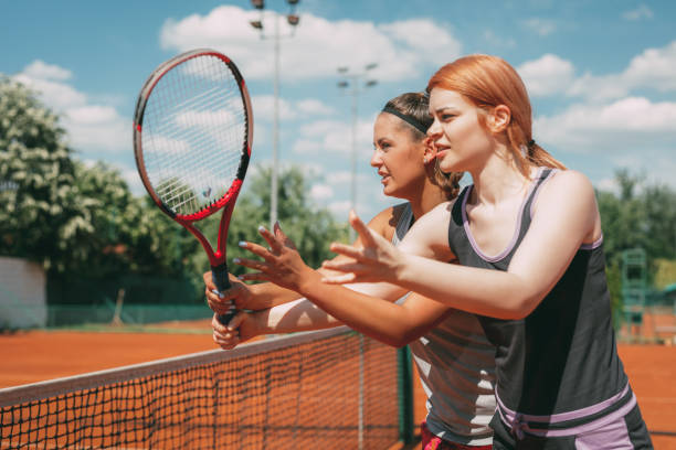 istock Girl Practice Tennis With Coach 1072614328