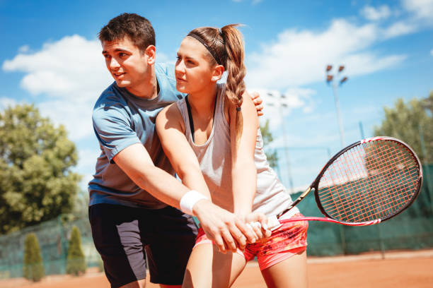 istock Girl Practice Tennis With Coach 1072616370