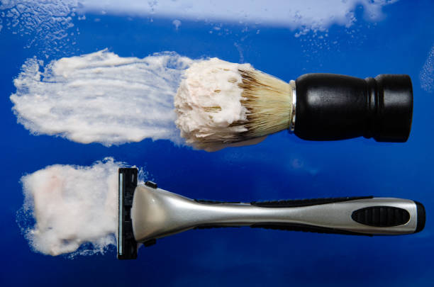 istock Shaving accessories. Razor and shaving brush. Top view . 1072617628