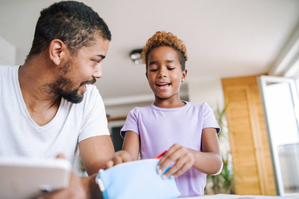 istock Father and daughter working on homework together 1072618040