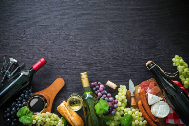 istock Wine bottles with grapes, cheese, ham and corks 1072623164