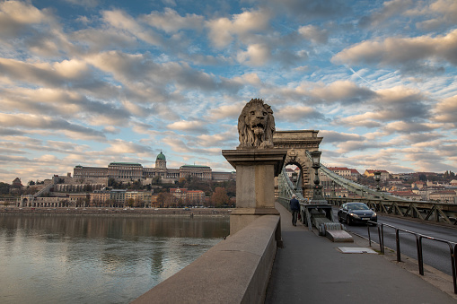 A view of the historic Chain Bridge with Buda Castle in the background in Budapest, Hungary.