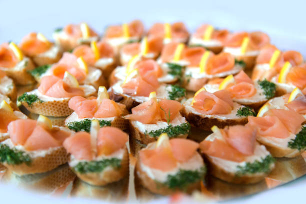 istock Close up of small canapes arranged on a plate over light background - selective focus 1072628780