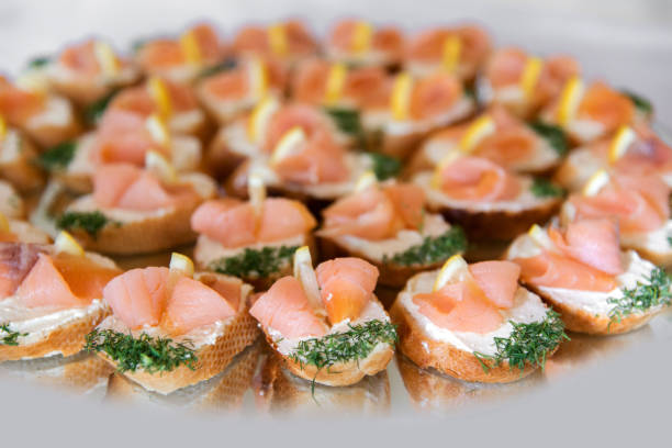 istock Close up of small canapes arranged on a plate over light background - selective focus 1072628790