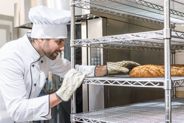 istock Side view of baker in gloves taking bread 1072630690