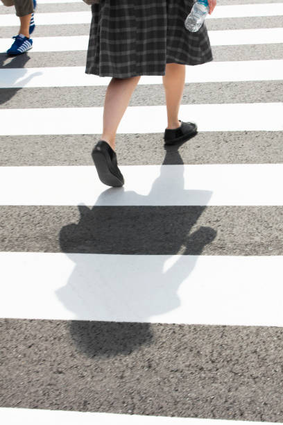 istock Feet Walking Across a Crosswalk 1072630970