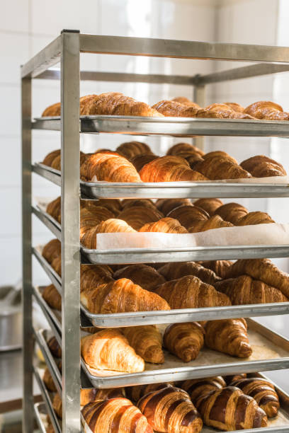 istock golden french croissants on baking trays at kitchen rack 1072635530