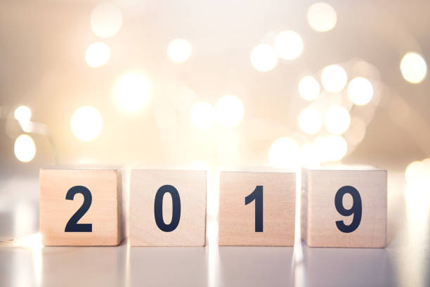 istock Wooden cubes with Happy new year 2019 with light bokeh background with copy space for text. 1072635768