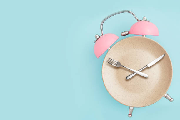 istock Alarm clock and plate with cutlery . 1072637446