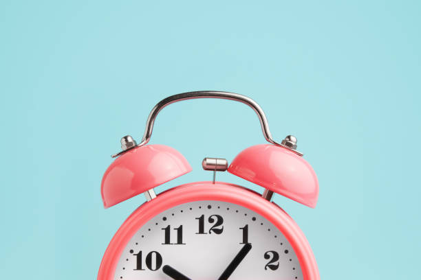 Red alarm clock on blue background Red alarm clock on blue background school alarm stock pictures, royalty-free photos & images