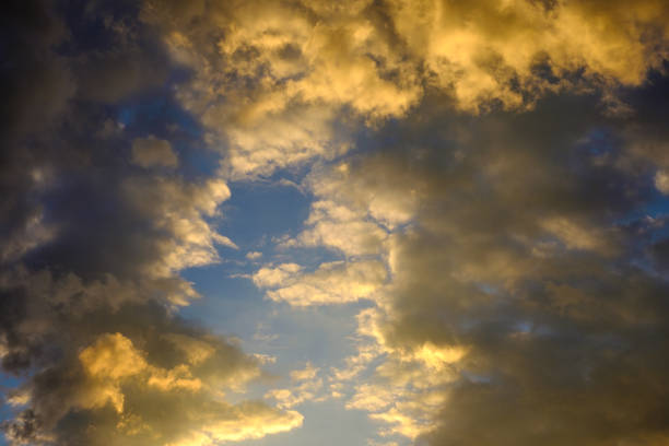 istock Red-yellow clouds in the blue sunset sky. 1072654394