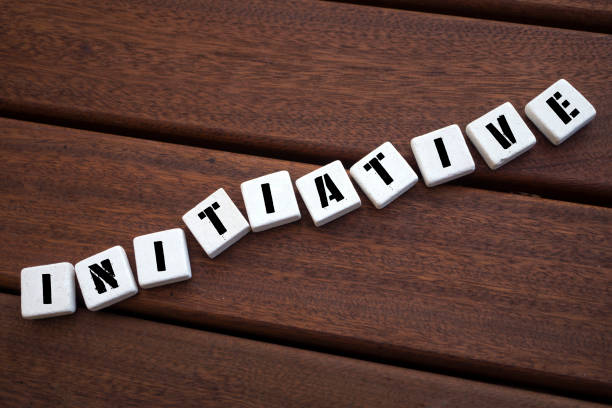 istock INITIATIVE Concept with alphabet blocks on wooden table. 1072656196