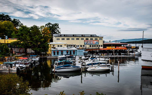 Meredith, New Hampshire, USA - August 15, 2017: boats on a mooring on Lake Winnipesaukee in New Hampshire, USA, tourist recreation area in the city of Meredith, New Hampshire,  The picturesque embankment of Lake Winnipesok. Summer holidays in New England