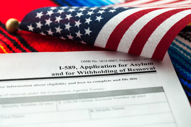 Application for asylum to USA concept with application form and USA flag on Mexican serape stock photo