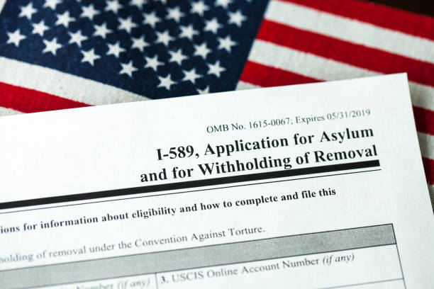 istock Application for asylum to USA concept with application form and USA flag 1072666954