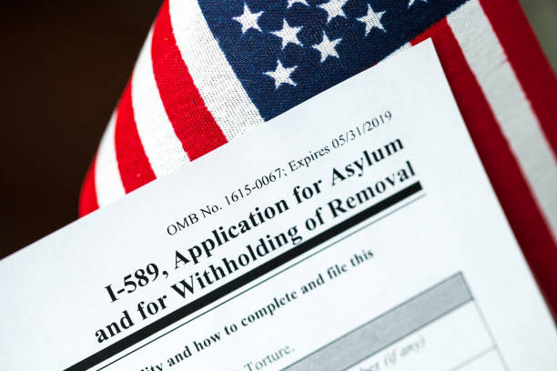 Application for asylum to USA concept with application form and USA flag stock photo