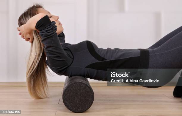 Mindful Workout Holistic Health Care Woman Doing Foam Roller Exercises To Relieve Back Pain Stock Photo - Download Image Now