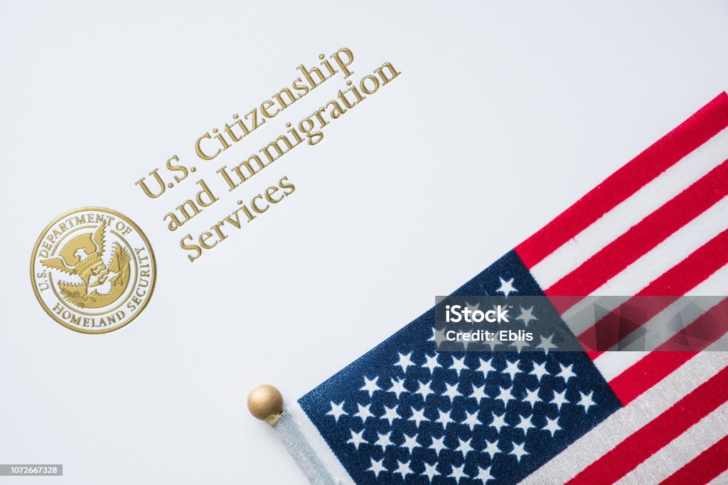 Envelope from U.S. Citizenship and Immigration Services with the American flag on top/U.S. immigration concept Emigration and Immigration Stock Photo