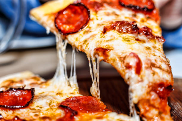 istock Hot pizza slice, melting cheese, pizza piece, pepperoni pizza, 1072669770