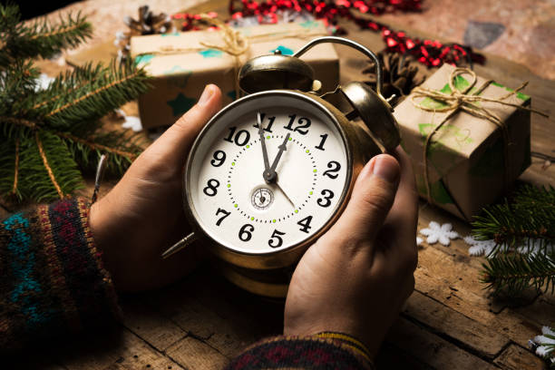 istock Man holding a clock on New Year eve 1072670524