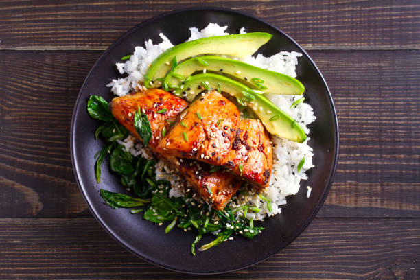 istock Salmon teriyaki rice bowl with spinach and avocado 1072675728