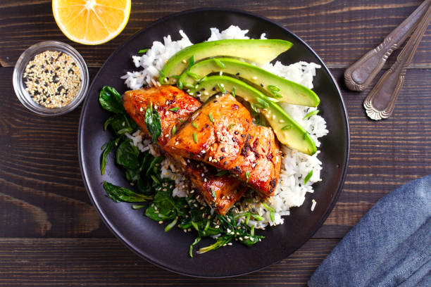 istock Salmon teriyaki rice bowl with spinach and avocado 1072675826