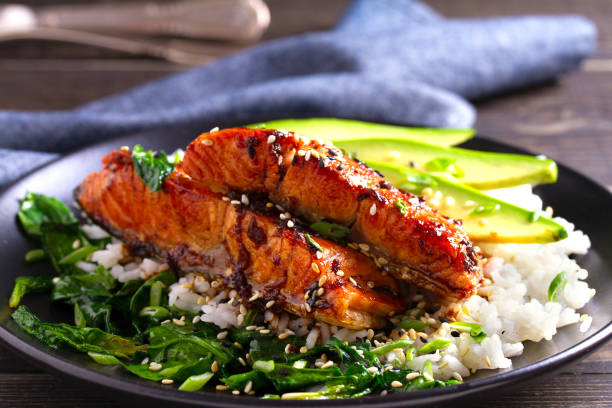 istock Salmon teriyaki rice bowl with spinach and avocado 1072675956