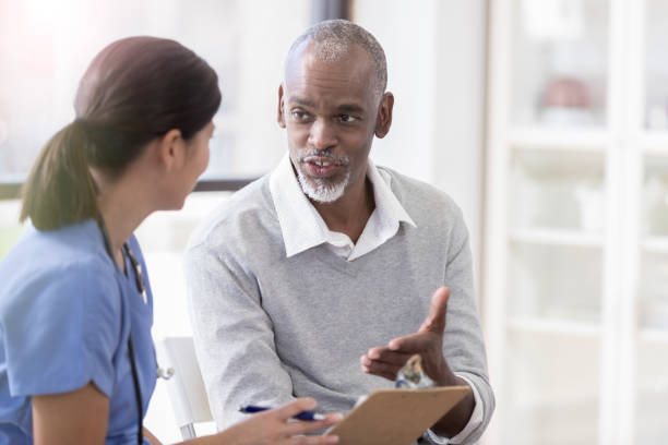 istock Senior man asks a doctor a question during appointment 1072676124