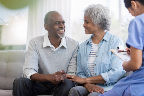 istock Cheerful senior man talks with female doctor 1072676144