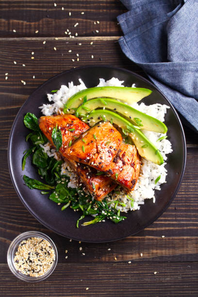istock Salmon teriyaki rice bowl with spinach and avocado 1072676368
