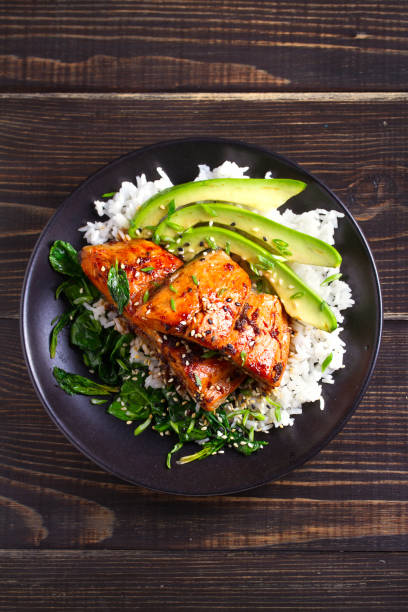 istock Salmon teriyaki rice bowl with spinach and avocado 1072676482