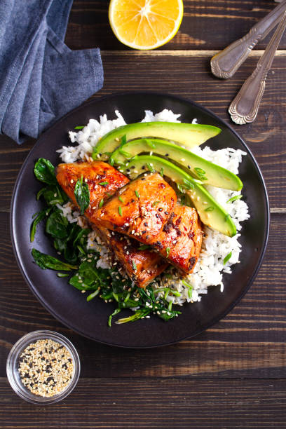 istock Salmon teriyaki rice bowl with spinach and avocado 1072676536