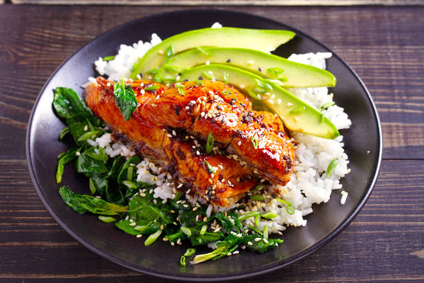 istock Salmon teriyaki rice bowl with spinach and avocado 1072676698