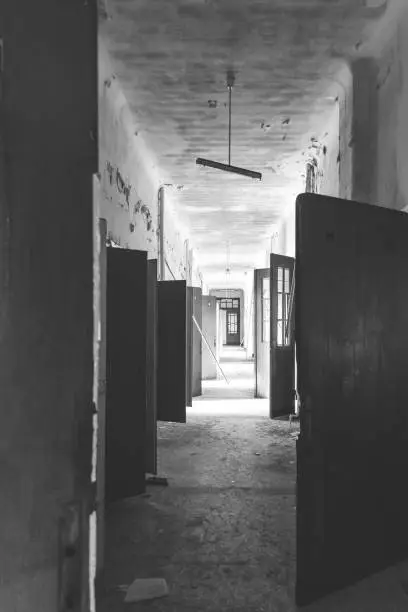abandoned building with open doors in black and white