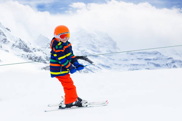 istock Child on ski lift. Kids skiing. 1072679220