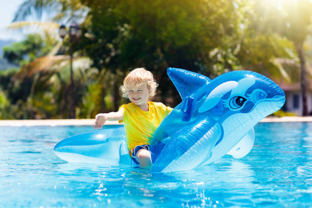 istock Child in swimming pool. Kid on inflatable float 1072679952