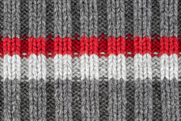 istock Pattern by gray, red and white knitting wool yarn texture, kraft handmade 1072684580