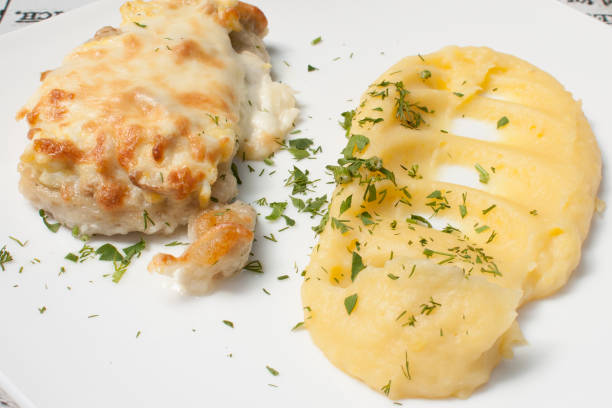istock baked chicken fillet with cheese and mashed potatoes 1072685034