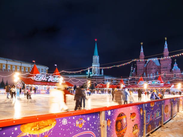 Famous skating rink on Red square near GUM (Main department store). Ice-skating people, shooting with long-exposure. Moscow, Russia - December 03, 2017. Famous skating rink on Red square near GUM (Main department store). Ice-skating people, shooting with long-exposure. long exposure winter crowd blurred motion stock pictures, royalty-free photos & images