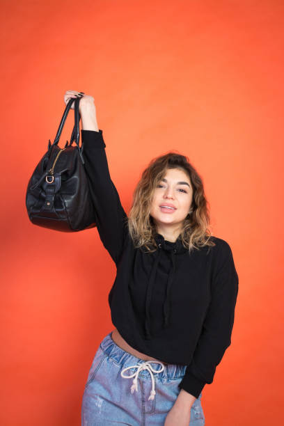 istock Shopping abstract: beautiful girl with a black bag 1072689274