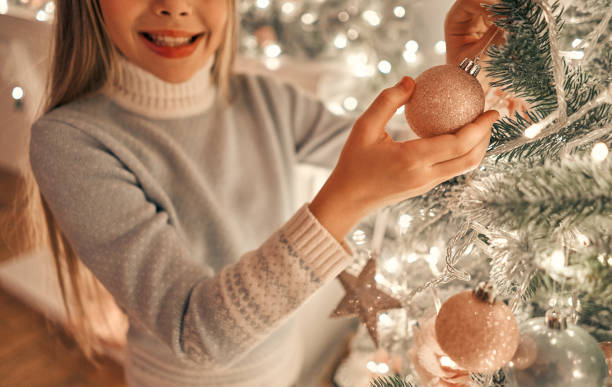 istock The girl decorating the christmas tree 1072689700