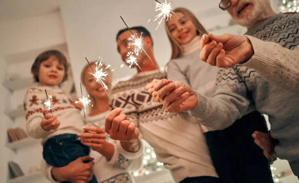 Photo of The happy family with bright sparklers