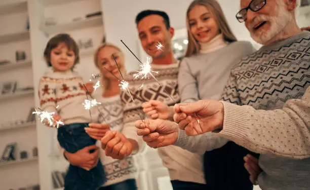 Photo of The happy family with bright sparklers