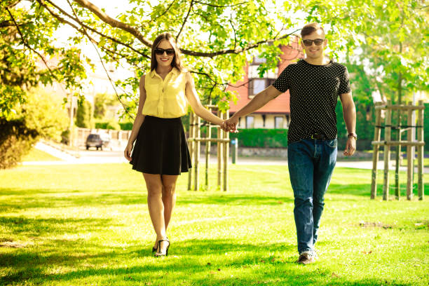 istock Couple holding hands in park. 1072693096