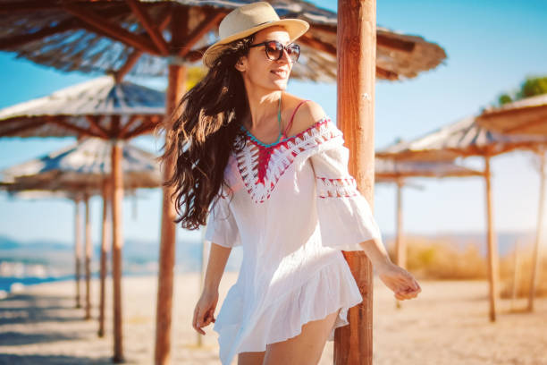istock happy woman enjoying on the beach 1072695650