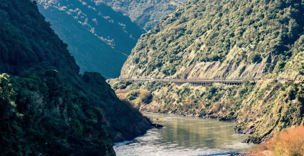 Landscape image of the Manawatu Gorge taken on it's last operational day. The gorge was closed permanently after landslides made it unsafe for travel. Landscape image of the Manawatu Gorge taken on it's last operational day. The gorge was closed permanently after landslides made it unsafe for travel. Palmerston North stock pictures, royalty-free photos & images