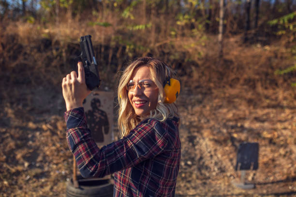 Image of a hunter stalking prey in the deep woods. There is a growing culture of women hunting. Useful image for any hunting/outdoor enthusiast theme.