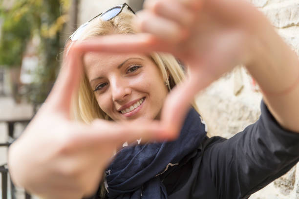 istock Girl makes frame with hands for photos. 1072715534