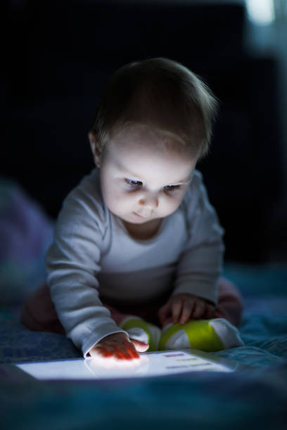 istock Baby child and tablet pc light night 1072747528